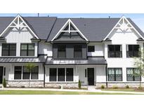 Charming modern farmhouse-style townhome featuring black window frames and a metal roof at 316 Church St, Morrisville, NC 27560