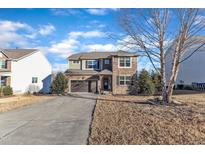 Charming two-story home featuring stone accents, attached two-car garage, and a well-manicured front lawn at 664 Long Melford Dr, Rolesville, NC 27571