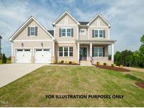 Two-story house with a large front yard, two-car garage, and neutral color palette at 1021 Smoke Willow Way # 130, Rolesville, NC 27571