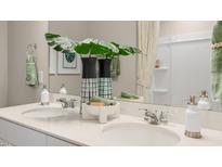 Double vanity bathroom with modern fixtures and a large mirror at 104 Kobus Ct, Garner, NC 27529