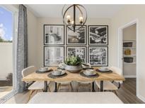 Bright dining room features a wood table, six chairs, and a large gallery wall at 120 Kobus Ct, Garner, NC 27529