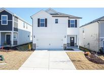 Two-story white house with a two-car garage and landscaped yard at 1388 Fruit Cobbler Dr, Haw River, NC 27258