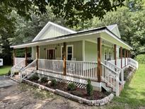 Charming craftsman style home with a large front porch and landscaped yard at 1610 Woodards Dairy Rd, Middlesex, NC 27557