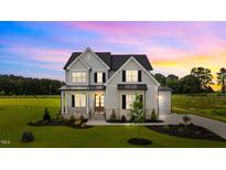 Gorgeous two-story home with a manicured lawn and craftsman-style architecture at 190 Broadleaf Ln, Youngsville, NC 27596