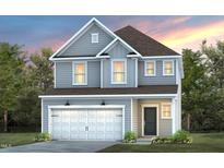 Two-story house with gray siding, white garage door, and landscaping at 2907 Huxley Way, Apex, NC 27502