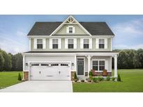 Two-story home with a white garage door, inviting front porch, and manicured lawn at 1024 Country Pasture Cv, Wendell, NC 27591