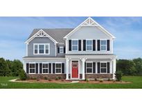 Two-story home with gray siding, red door, and stone accents at 1036 Country Pasture Cv, Wendell, NC 27591