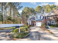 Charming home featuring a well-manicured front yard, inviting driveway, and a mailbox surrounded by vibrant greenery at 2112 White Pond Ct, Apex, NC 27523