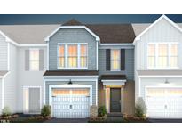 Two-story townhome with gray siding, brick accents, and a two-car garage at 248 Broomside Ave, Raleigh, NC 27603