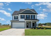 Two-story house with gray siding, white trim, and a two-car garage at 339 Suhani Ln, Clayton, NC 27520