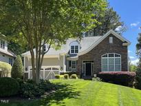 Two-story house with stone accents and a three-car garage at 7320 Dunsany Ct, Wake Forest, NC 27587
