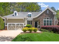 Charming home with a stone facade, well-manicured lawn, and a two-car garage on a sunny day at 7320 Dunsany Ct, Wake Forest, NC 27587