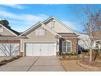 Tan house with stone accents and a two-car garage at 755 Finnbar Dr, Cary, NC 27519