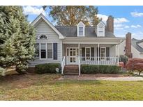 Charming single-story home with a gray exterior, landscaped lawn, and a welcoming front porch at 101 Stefi Ct, Garner, NC 27529