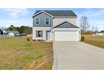 Two-story house with gray siding, white trim, and a two-car garage at 41 Alderman Ct, Dunn, NC 28334