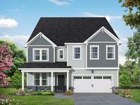 Two-story house with gray siding, white garage door, and stone accents at 4813 Bristol Meadow Dr, Raleigh, NC 27603