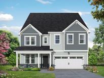 Two-story house with gray siding, white garage door, and stone accents at 5028 Trotter Dr, Raleigh, NC 27603