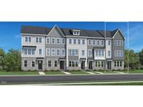 Three-story townhouses with gray siding and white trim at 522 Billingshurst Way, Knightdale, NC 27545