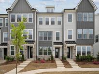 Attractive new construction townhomes featuring gray siding and stone accents at 524 Billingshurst Way, Knightdale, NC 27545