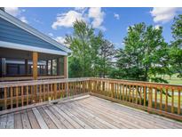 Spacious wooden deck overlooking a golf course with a screened-in porch, perfect for outdoor relaxation at 861 Parc Townes Dr # 6, Wendell, NC 27591