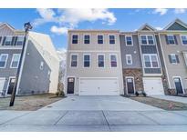 Two-story townhome with attached garage and neutral siding at 871 Parc Townes Dr # 1, Wendell, NC 27591
