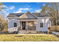 Newly renovated cottage with a charming front porch and well-manicured lawn at 1004 N Fayetteville Ave, Dunn, NC 28334