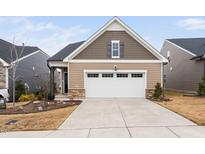 Attractive craftsman style home with two-car garage and landscaped front yard at 1008 Ashton Oak Ct, Durham, NC 27703