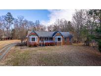Brick ranch house with a large front yard and mature trees at 1140 E Harden St, Graham, NC 27253