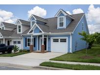 Exterior of charming two-story home with blue siding and brick accents at 1741 Old Fields Blvd, Haw River, NC 27258