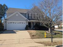 Two-story house with attached garage and landscaping at 2037 Summer Shire Way, Raleigh, NC 27604
