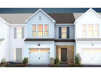 Two-story townhome with light-grey siding, dark-grey roof, and a brick entryway at 246 Broomside Ave, Raleigh, NC 27603
