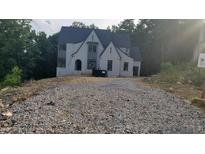 New construction two-story home with modern design elements and a wooded backdrop at 286 W Beech Slope Ct, Chapel Hill, NC 27517