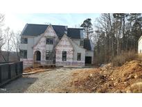 Two-story house under construction, featuring a charming architectural design and large windows at 286 W Beech Slope Ct, Chapel Hill, NC 27517