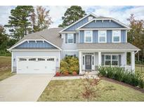 Two-story house with gray siding, stone accents, and a two-car garage at 55 Watermelon Dr, Franklinton, NC 27525