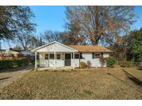 Charming ranch home with a well-manicured lawn and mature trees at 607 Calloway Dr, Raleigh, NC 27610