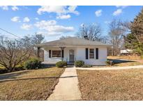 Charming white house with a covered porch and well-maintained lawn at 1413 Longhurst St, Roxboro, NC 27573