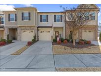Two-story townhome with attached garage and landscaped front yard at 2209 Sweet Annie Way, Wake Forest, NC 27587