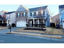 Two-story brick home with gray siding, two-car garage, and landscaping at 302 Glenview Ln, Durham, NC 27703