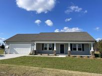 Newly constructed one-story home with gray siding, attached garage, and front porch at 57 Shiloh Dr, Lillington, NC 27546