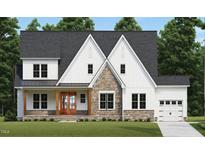 Two-story farmhouse with stone accents, wood front door, and a two-car garage at 1116 Delilia Ln, Wake Forest, NC 27587