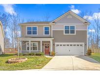 Charming two-story home features a welcoming front porch and well-manicured landscaping at 1398 Salters St, Burlington, NC 27215