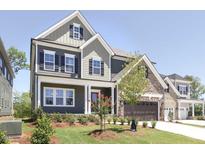 Two-story home with stone and siding accents, landscaped yard at 1925 Edgelake Pl, Cary, NC 27519