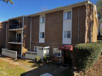 Brick condo building with balconies and landscaping at 4519 Edwards Mill Rd # J, Raleigh, NC 27612