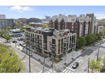 Modern condominium building showcasing a mix of brick and contemporary design in an urban setting at 615 W Peace St # 307, Raleigh, NC 27605