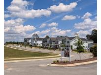 Allen Park community featuring colorful homes and beautiful landscaping under a partially cloudy sky at 942 Allen Park Dr, Knightdale, NC 27604