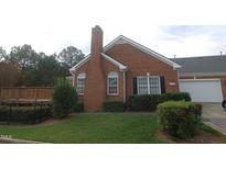 Brick home with deck and landscaped yard at 2004 Clyde Bank Ct, Cary, NC 27511
