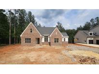 New construction single-Gathering home featuring a brick facade and symmetrical gabled roofline at 7934 Wexford Waters Ln, Wake Forest, NC 27587