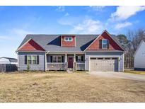 Gray and red two-story house with attached garage and front porch at 10080 Nc-39, Middlesex, NC 27557
