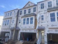 Three-story townhome under construction, showing exterior features and materials at 1204 Alston Landing Way # 07, Cary, NC 27519