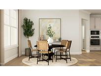 Bright dining area with round table and four chairs, ideal for Gathering meals at 1528 Goldfinch Perch Ln, Knightdale, NC 27545